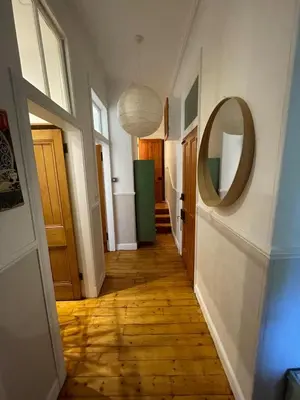 a hallway with a mirror on the wall and a hallway sidx sidx sidx at Charming flat in beautiful area in Edinburgh
