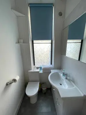 a bathroom with a sink and a toilet and a window at Charming flat in beautiful area in Edinburgh