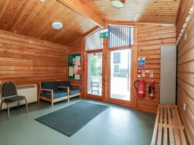 a room with a waiting room with wooden walls at Shore Lodge Brodick Castle in Brodick