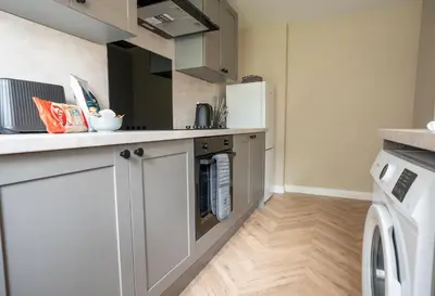 a kitchen with a refrigerator and a washer and dryer at Rise House in Livingston