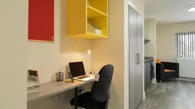 a room with a desk with a laptop and a chair at SOAB Residence in Hamilton