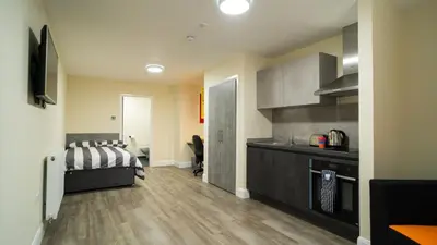 a room with a kitchen and a bed in a room at SOAB Residence in Hamilton