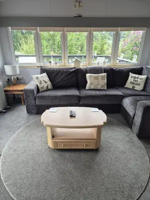 a living room with a couch and a coffee table at Shep2 Caravans in Ballantrae