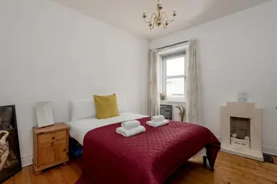 a bedroom with a bed with two towels on it at Double Edinburgh Homestay in Edinburgh