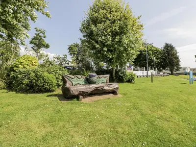 a couch sitting in the grass in a park at Manor Heights Lodge in Wemyss Bay