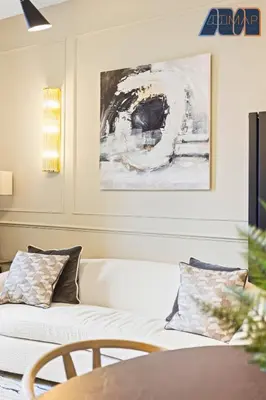a living room with a white couch and a painting at 3Bed Sleeps6 EdinburghCityCentre in Edinburgh