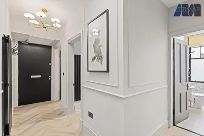 a hallway with white walls and a black door at 3Bed Sleeps6 EdinburghCityCentre in Edinburgh