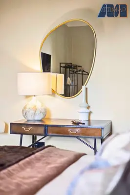 a dressing table with a mirror and a lamp on it at 3Bed Sleeps6 EdinburghCityCentre in Edinburgh