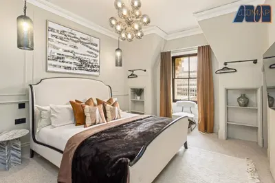 a bedroom with a large bed and a chandelier at 3Bed Sleeps6 EdinburghCityCentre in Edinburgh