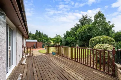 a wooden deck with a fence on a house at Spacious 4BD Home with Stunning Oban Views in Oban