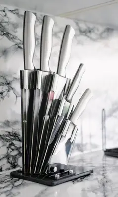 a group of knives in a holder on a counter at 3 BDR House By Caledonia Luxe Stays Short Lets & Serviced Accommodation West Calder in West Calder
