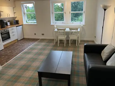 a living room with a couch and a table at Castle View Central Flat in Edinburgh