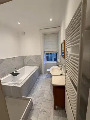 a bathroom with a large tub and a sink at Entire rental in Edinburgh City Centre in Edinburgh
