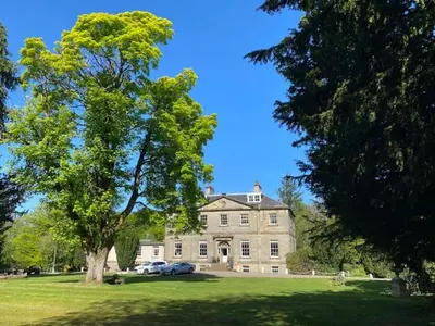 a large house with a tree in front of it at Limefield Mansion House in Livingston