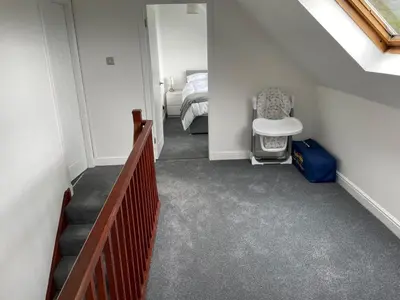 a hallway with a bedroom with a bed and a staircase at The Stables in Symington in Symington