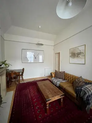a living room with a couch and a table at Little West End cottage in Edinburgh