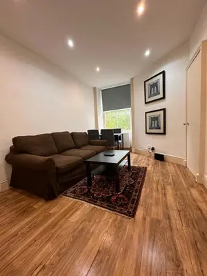 a living room with a couch and a table at Caledonian Apartment in Edinburgh