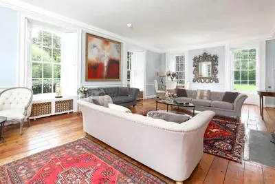 a living room with a white couch and a rug at Blossom Mansion in Edinburgh