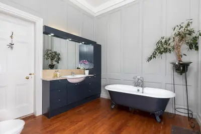 a bathroom with a bath tub and a sink at Blossom Mansion in Edinburgh