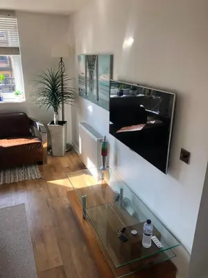 a living room with a glass table and a couch at 17 flat 11 slateford gait in Edinburgh