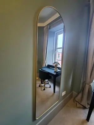 a mirror in a room with a table and a desk at Townhead Jewel by Coorie Doon Stays in Paisley