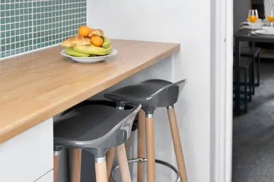 a wooden counter with a plate of fruit on it at Riverside City Apartment in Glasgow