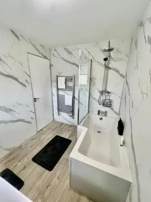 a white bathroom with a sink and a mirror at Newly refurbed 3 bed home 15mins to Edin city in Livingston