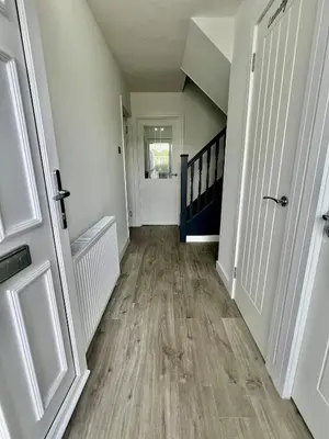 an empty hallway with a staircase in a house at Newly refurbed 3 bed home 15mins to Edin city in Livingston