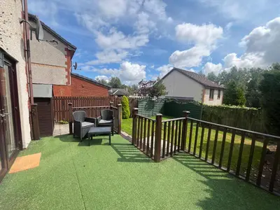 a yard with a fence and green grass at Bespoke home in Kirky in Kirknewton