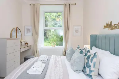 a bedroom with a bed with towels on it at The Compact Caledonian Flat - Haymarket in Edinburgh