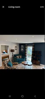 a living room with a couch and a table at The Wee Bothy in Oban