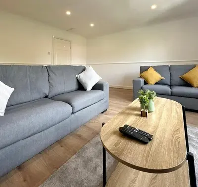 a living room with a couch and a table at Spacious 2 Bed Apartment Near Glasgow Airport in Glasgow