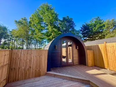 a small blue dome house on a wooden deck at 60 Mile Inn - Luxury Pods with Hot Tubs in Bridge of Orchy