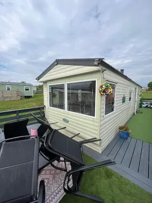 a tiny house with a golf cart on a deck at 108 Lochview in Newton Stewart
