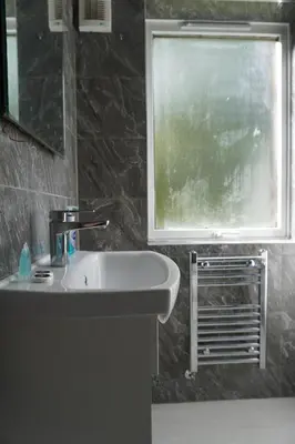 a bathroom with a sink and a window at Glasgow Group Getaway in Glasgow