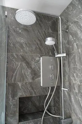 a shower with two lights in a bathroom at Glasgow Group Getaway in Glasgow