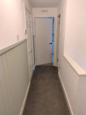 a hallway with a door leading to a closet at Millburn Chalet in Inverkip