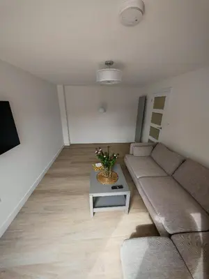 a living room with a couch and a table at Cozy corner 2 bedroom house in Edinburgh