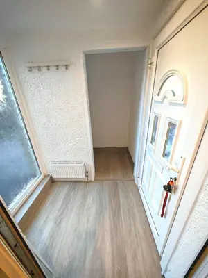 an empty room with a door and a window at Cozy corner 2 bedroom house in Edinburgh