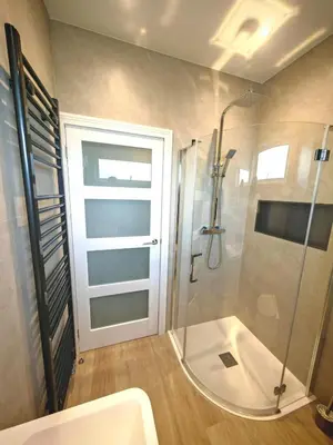a bathroom with a shower and a glass door at Cozy corner 2 bedroom house in Edinburgh