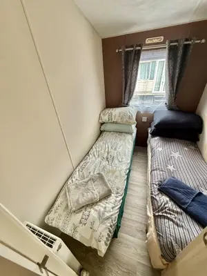 a small room with two beds and a window at Four-bed Delta Caravan, Uddingston, Glasgow Located in Uddingston, Glasgow at Maryville Caravan Site in Uddingston