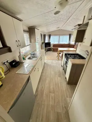 a kitchen with a sink and a stove at Four-bed Delta Caravan, Uddingston, Glasgow Located in Uddingston, Glasgow at Maryville Caravan Site in Uddingston