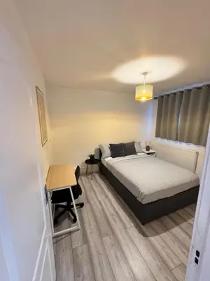 a bedroom with a bed and a desk and a table at Modern 3-Bed Flat Stylish Family-Friendly in Moffat