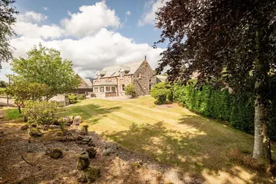 an estate with a large house and a yard at Kilmore Paws and Relax in Comrie