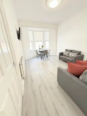 a living room with a couch and a table at 2Bed Gla Green, Walk Dist City Centre in Glasgow