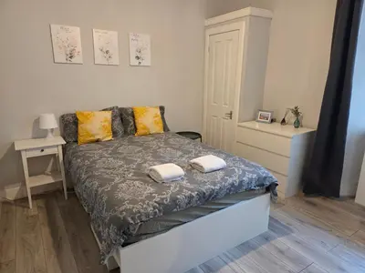 a bedroom with a bed with two towels on it at Stylish Flat in Historic Edinburgh city centre home in Edinburgh