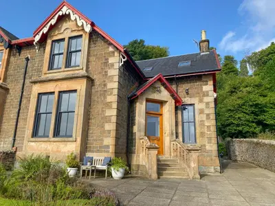 a brick house with a yellow door and stairs at Thornlie - Uk49875 in Blairmore
