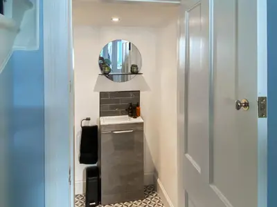 a small bathroom with a mirror and a sink at Thornlie - Uk49875 in Blairmore