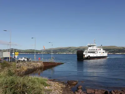 a boat is docked in a body of water at Cosy In in Millport