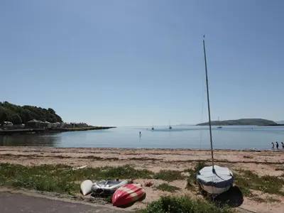 a beach with boats sitting on the sand at Cosy In in Millport